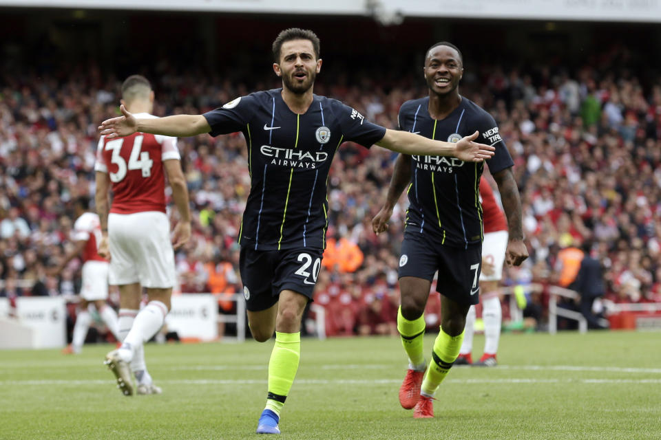 Manchester City's Bernardo Silva celebrates with teammate Raheem Sterling, right, after scoring his side's second goal during the English Premier League soccer match between Arsenal and Manchester City at the Emirates stadium in London, England, Sunday, Aug. 12, 2018. (AP Photo/Tim Ireland)