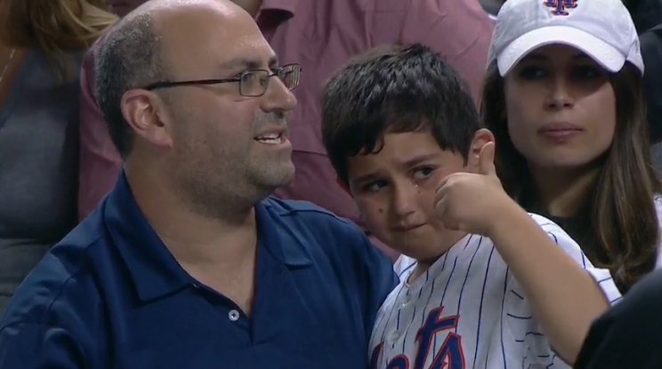 A Mets fan gives a thumbs up after being hit on the arm with a foul ball. (MLB.TV)