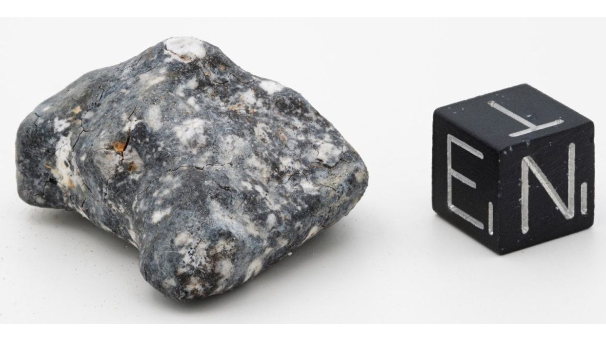  A black and white rock on a white background. 