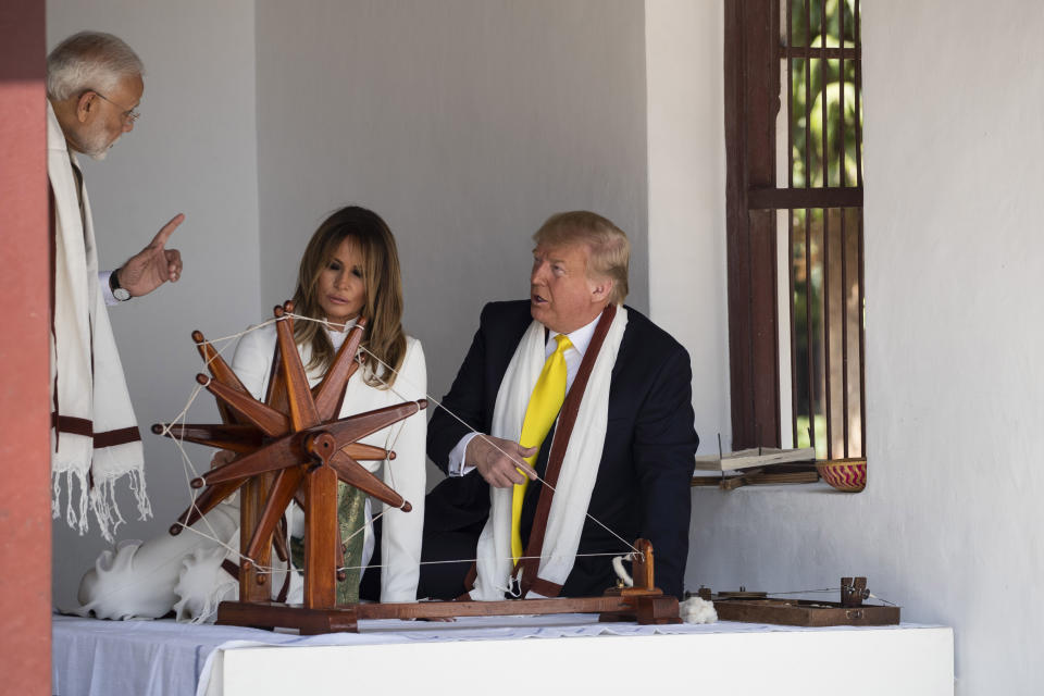 U.S. President Donald Trump, with first lady Melania Trump, and Indian Prime Minister Narendra Modi, look at a Charkha, or a spinning wheel, during a tour of Gandhi Ashram, Monday, Feb. 24, 2020, in Ahmedabad, India. After Air Force One touched down in Ahmedabad in western India, Trump's motorcade slowly drove down streets lined with hundreds of thousands of onlookers. He began that day's high-wattage trio of presidential photo-ops: a visit to a former home of independence leader Mohandas Gandhi, a rally at a huge cricket stadium and a trip to the famed Taj Mahal. (AP Photo/Alex Brandon)