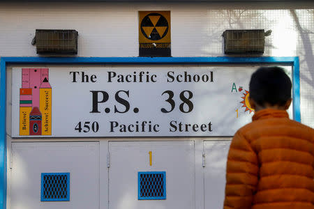 A yellow nuclear fallout shelter sign is seen hung over the entrance to P.S. 38 in the Brooklyn borough of New York, U.S., December 7, 2017. Picture taken December 7, 2017. REUTERS/Brendan McDermid