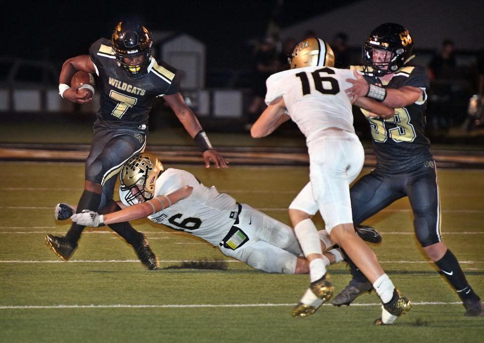 Archer City Wildcats quarterback Elijah Jackson (7) is dropped for a loss by Henrietta linebacker Klein Essler (46) Friday night in Archer City.