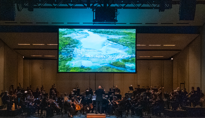 The QCSO performing “Liquify” with the accompanying KV 265 film, on Feb. 3, 2024 at the Adler Theatre (photo by Evan Sammons).