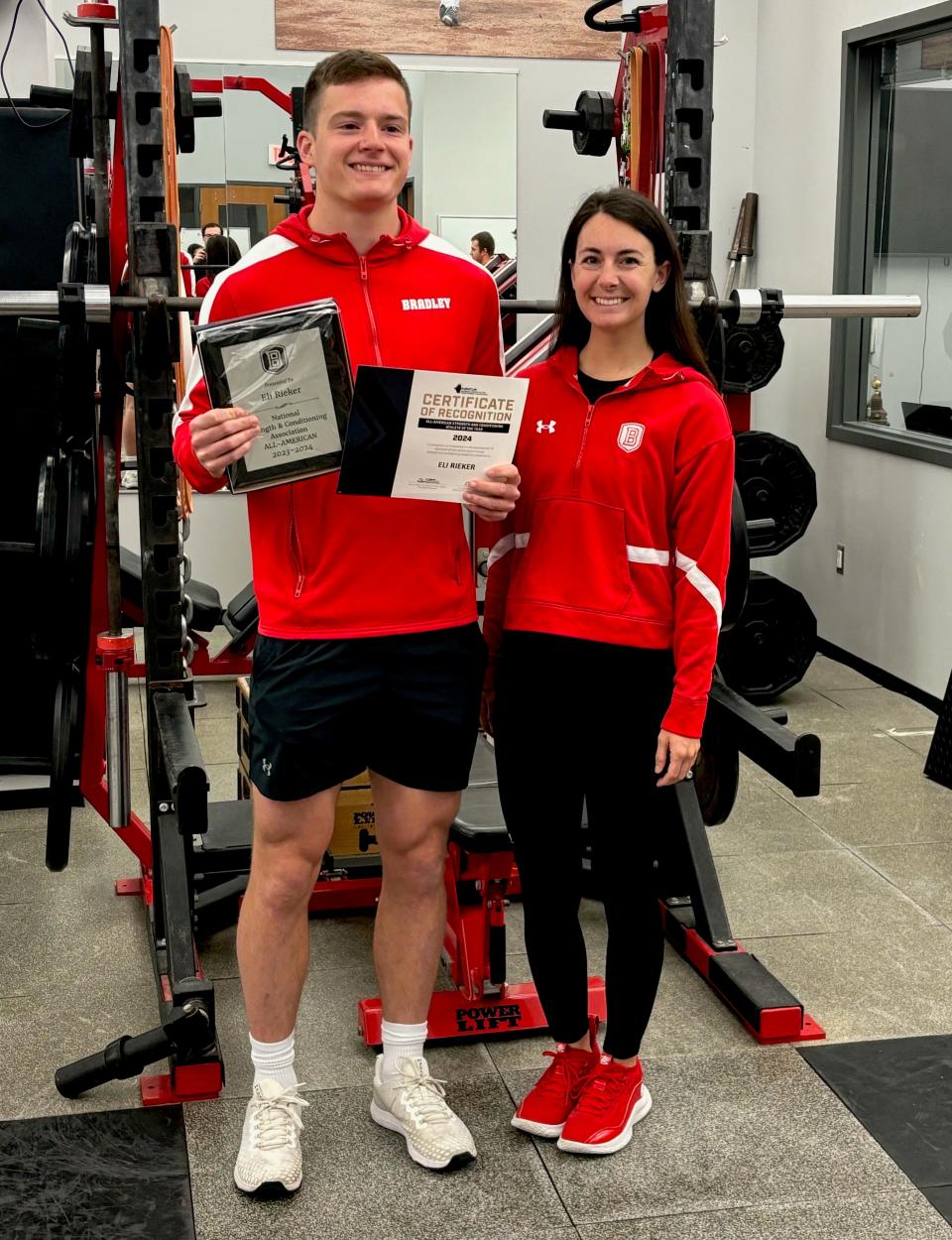 Bradley University track and field star Eli Rieker celebrates his national training recognition with BU associate director of sports performance Josie Jay.