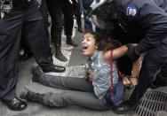 Policemen arrest an Occupy Wall Street movement supporter while they were marching from Zuccotti Park to Union Square to protest perceived police brutality in New York, March 24, 2012.