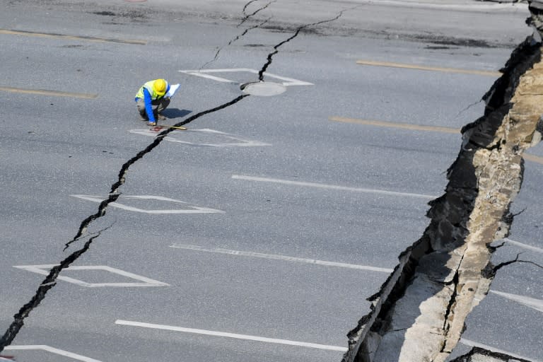 The road collapsed after a sudden leak flooded the subway station construction site beneath it