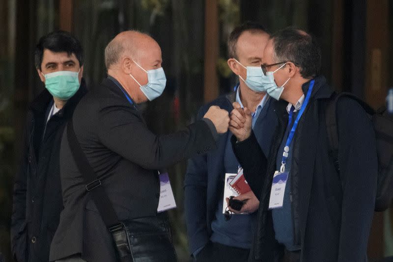 Members of the World Health Organization team, tasked with investigating the origins of the coronavirus disease (COVID-19), Peter Daszak and Peter Ben Embarek fist-bump as they leave their hotel in Wuhan