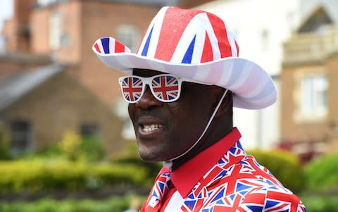  A man wears a Union Jack suit with matching hat and glasses as he waits 24 hours before for the procession on the Long Walk - Credit: James D. Morgan/Getty Images Europe