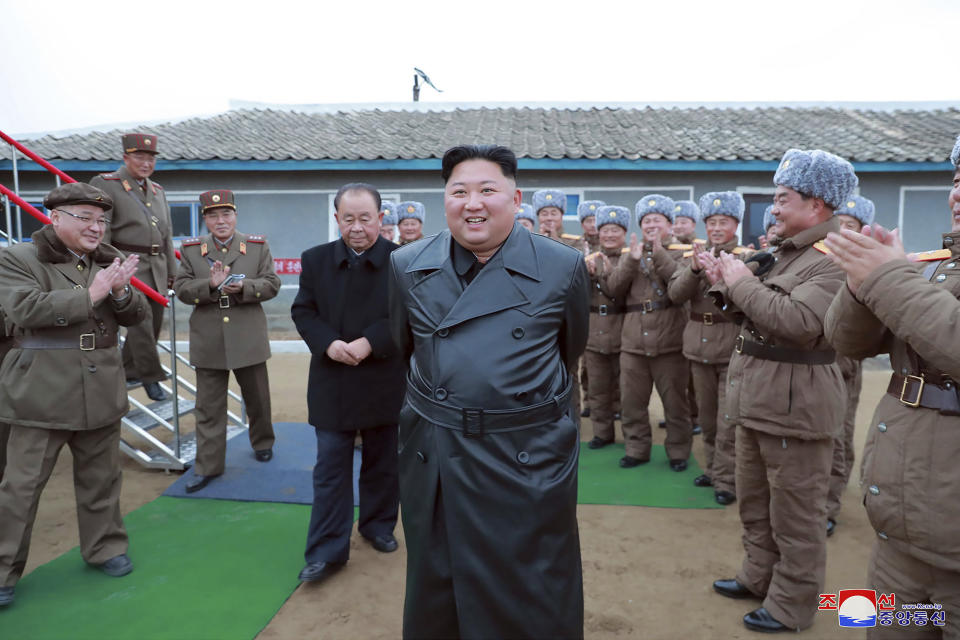 FILE - This undated photo provided on Nov. 29, 2019, by the North Korean government shows North Korean leader Kim Jong Un, center, surrounded by a military unit, reacts to what it claims as a test firing of its "super-large" multiple rocket launcher in North Korea. The content of this image is as provided and cannot be independently verified. Korean language watermark on image as provided by source reads: "KCNA" which is the abbreviation for Korean Central News Agency. (Korean Central News Agency/Korea News Service via AP, File)