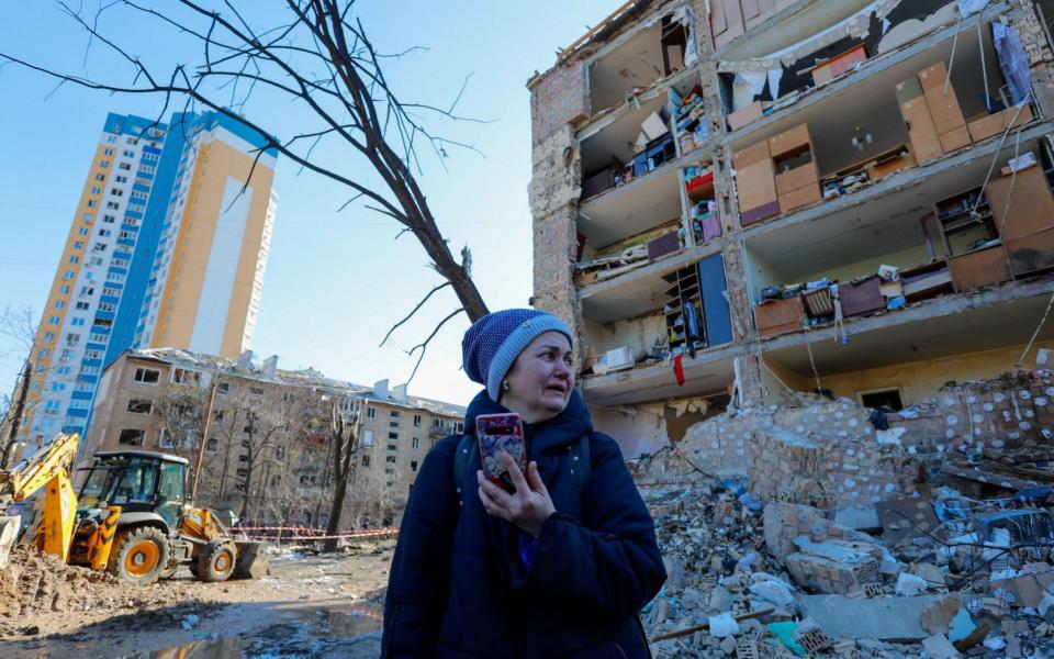 A resident bursts into tears outside a severely damaged 5-storey residence - Zuma