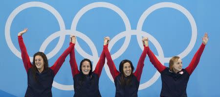 2016 Rio Olympics - Swimming - Victory Ceremony - Women's 4 x 200m Freestyle Relay Victory Ceremony - Olympic Aquatics Stadium - Rio de Janeiro, Brazil - 10/08/2016. Allison Schmitt (USA) of USA, Leah Smith (USA) of USA, Maya DiRado (USA) of USA and Katie Ledecky (USA) of USA celebrate winning the gold. REUTERS/Marcos Brindicci