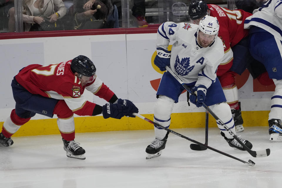 Florida Panthers center Evan Rodrigues (17) takes control of the puck from Toronto Maple Leafs defenseman Morgan Rielly (44) during the second period of an NHL hockey game, Thursday, Oct. 19, 2023, in Sunrise, Fla. (AP Photo/Marta Lavandier)
