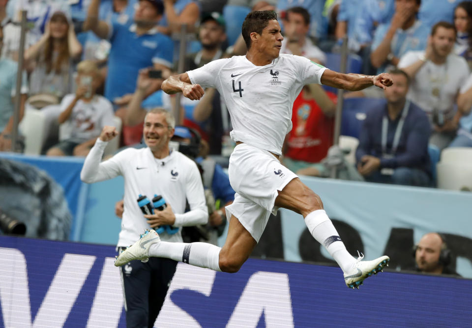 <p>France’s Raphael Varane, right, celebrates after scoring his side’s opening goal </p>