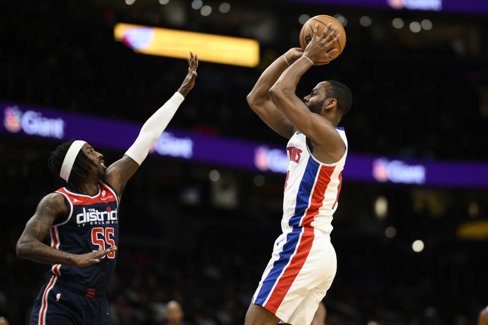 Detroit Pistons guard Alec Burks, right, looks to shoot against Washington Wizards guard Delon Wright (55) during the first half of an NBA basketball game, Monday, Jan. 15, 2024, in Washington. (AP Photo/Nick Wass)