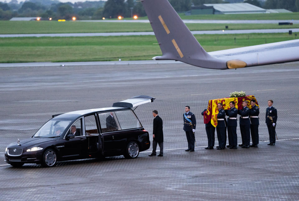 The coffin of Queen Elizabeth II is carried off a plane by the Queen's Colour Squadron at RAF Northolt. (Getty Images)