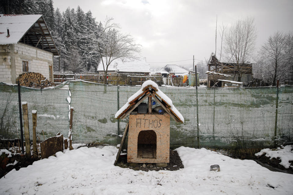 An improvised house for Athos the dog is covered in snow in Nucsoara, Romania, Saturday, Jan. 9, 2021. Valeriu Nicolae and his team visited villages at the foot of the Carpathian mountains, northwest of Bucharest, to deliver aid. The rights activist has earned praise for his tireless campaign to change for the better the lives of the Balkan country’s poorest and underprivileged residents, particularly the children. The rights activist has earned praise for his tireless campaign to change for the better the lives of the Balkan country’s poorest and underprivileged residents, particularly the children. (AP Photo/Vadim Ghirda)