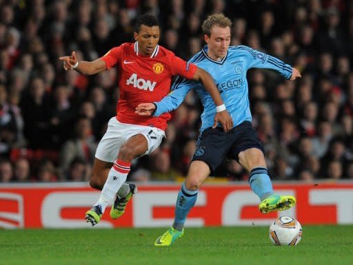 Ajax Amsterdam's Christian Eriksen (R) vies with Manchester United's Nani during their UEFA Europa League round of 32 second leg between Manchester United and Ajax at Old Trafford in Manchester, north-west England, on February 23. United were beaten 2-1 but a 2-0 first leg lead carried them through in nervous fashion