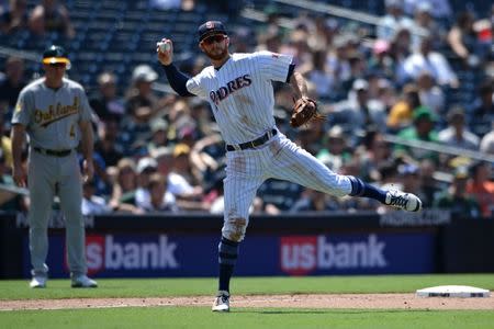 Jun 20, 2018; San Diego, CA, USA; San Diego Padres third baseman Cory Spangenberg throws to first base late on a ball hit by Oakland Athletics center fielder Jake Smolinski (not pictured) during the eighth inning at Petco Park. Mandatory Credit: Orlando Ramirez-USA TODAY Sports