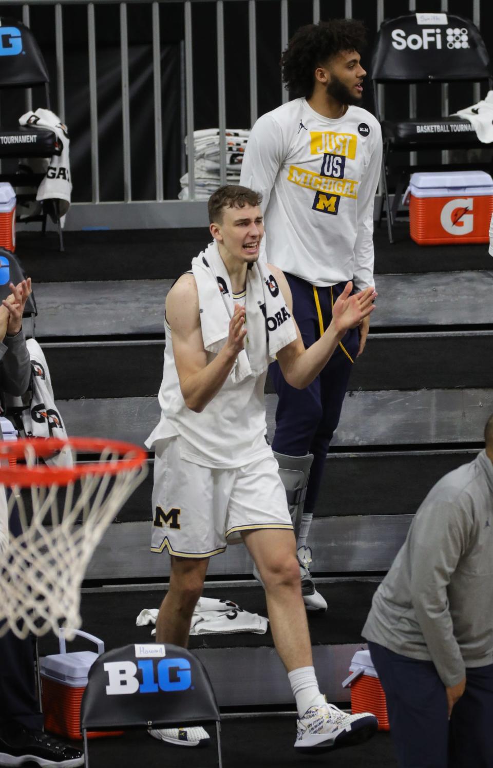 Michigan guard Franz Wagner (21) and forward Isaiah Livers (2) cheer on their teammates during the Big Ten tournament Saturday, March 13, 2021, at Lucas Oil Stadium in Indianapolis.