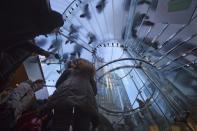 Shoppers are pictured inside an Apple store on 5th Ave during Black Friday Sales in New York November 29, 2013. Black Friday, the day following Thanksgiving Day holiday, has traditionally been the busiest shopping day in the United States. REUTERS/Carlo Allegri