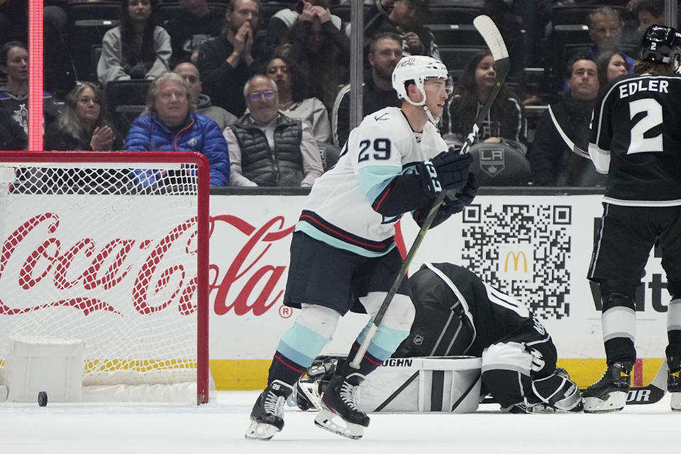 Seattle Kraken defenseman Vince Dunn, left, celebrates a game-winning goal by left wing Andre Burakovsky as Los Angeles Kings goaltender Cal Petersen lays on the ice during overtime an NHL hockey game Tuesday, Nov. 29, 2022, in Los Angeles. (AP Photo/Mark J. Terrill)