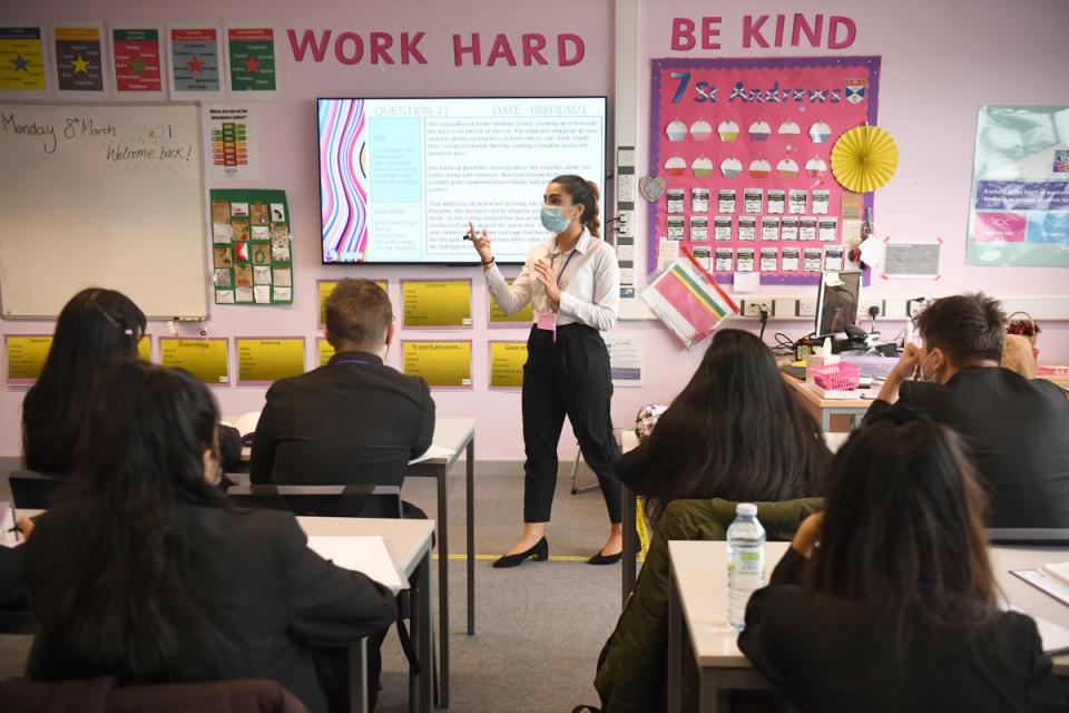 A teacher pictured wearing a face mask while giving a lesson (PA Archive)