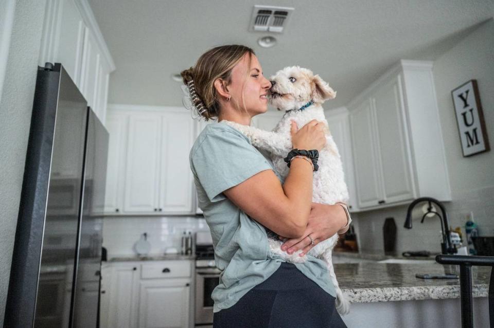 Olivia Keller snuggles her dog Rory at her home in Lincoln on Oct. 3.