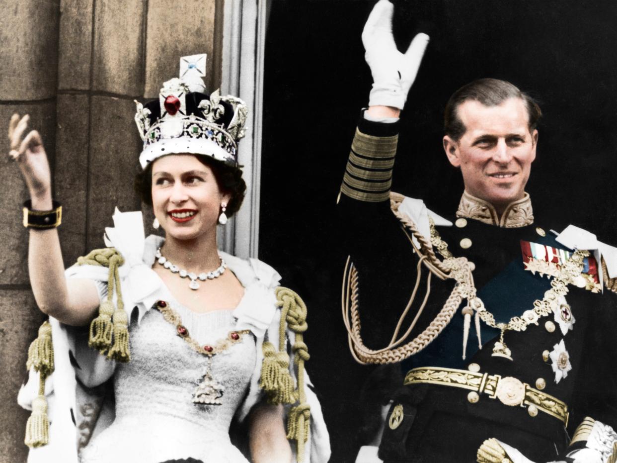Queen Elizabeth II and the Duke of Edinburgh waving.