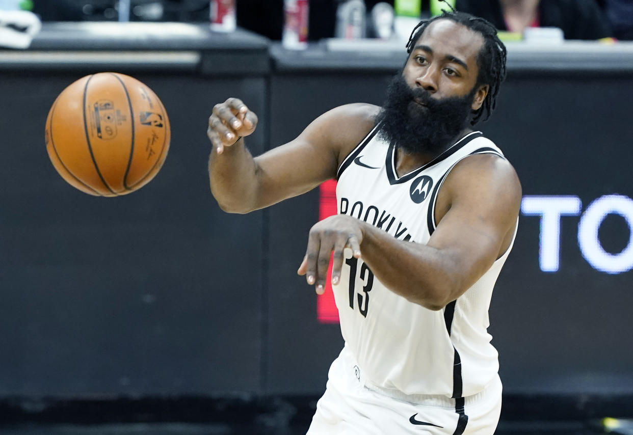James Harden with the ball in front of his after he fires off a pass.