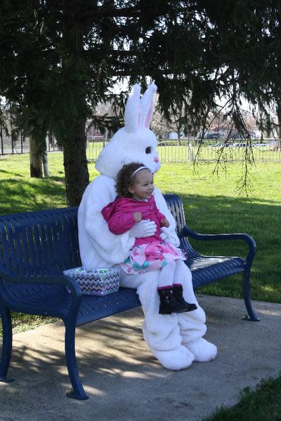 Lily Bouvier, 2, visits with the Easter Bunny during the annual Easter Egg Hunt held by the Clarksville Parks Department at Colgate Park on Saturday.