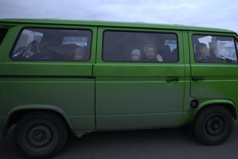 A family from Ukraine arrives at the border crossing in Medyka, southeastern Poland, Wednesday, March 2, 2022. Seven days into the war, roughly 874,000 people have fled Ukraine and the U.N. refugee agency warned the number could cross the 1 million mark soon. (AP Photo/Markus Schreiber)