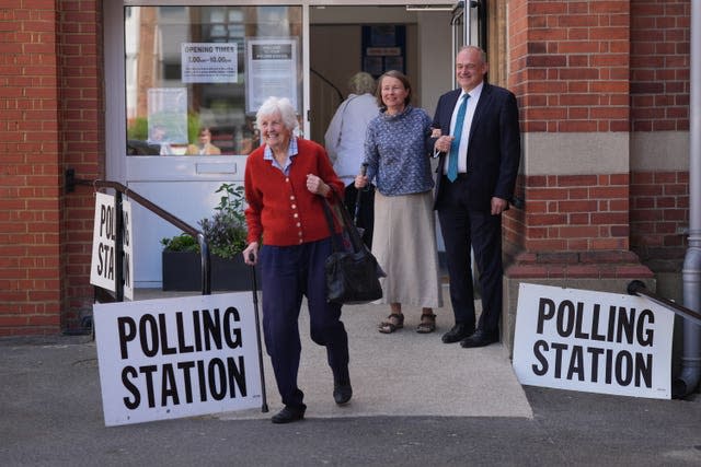 Sir Ed Davey and his wife Emily Gasson leave a polling station