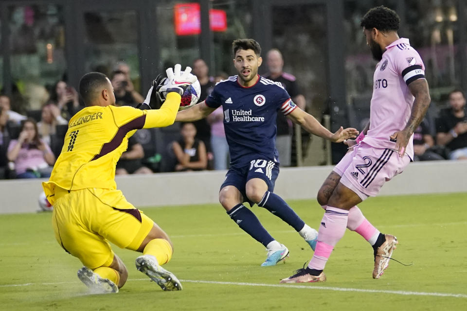 Inter Miami goalkeeper Drake Callender (1) makes a save against New England Revolution midfielder Carles Gil (10) during the first half of an MLS soccer match Saturday, May 13, 2023, in Fort Lauderdale, Fla. (AP Photo/Lynne Sladky)
