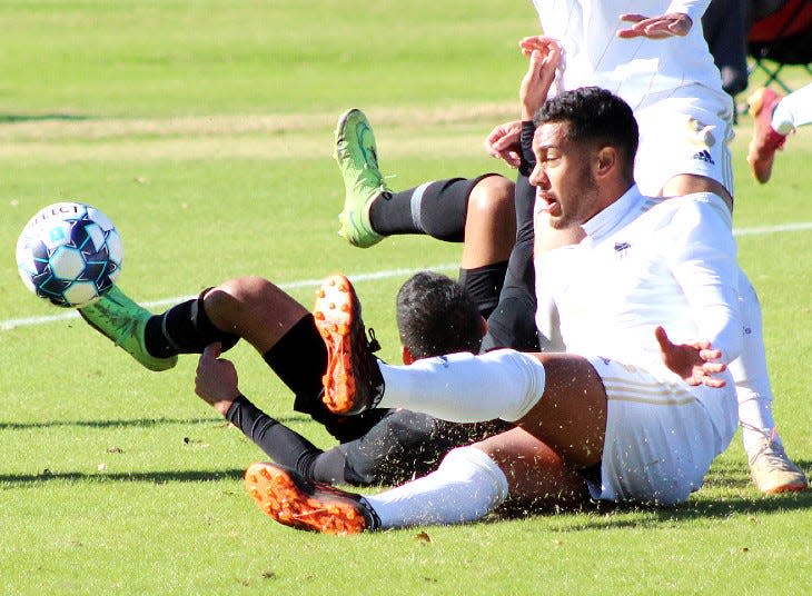 An Oklahoma Wesleyan University battler, right, scraps for the ball during NAIA regional tournament play last weekend in Bartlesville. OKWU defeated Governors (Ill.) State and Lyon (Ark.) College to advance to the NAIA national finals' site in Decatur, Ala., in late November.