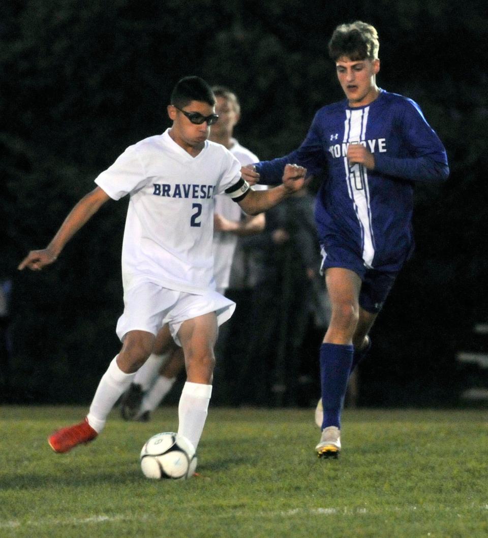 Logan Ayers (2) of Dundee/Bradford tries to get past the defense of Honeoye's Owen Baader.