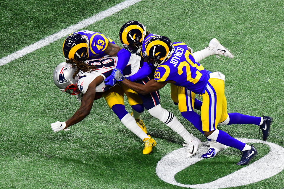 <p>John Johnson #43, Nickell Robey-Coleman #23, and Lamarcus Joyner #20 of the Los Angeles Rams tackle Cordarrelle Patterson #84 of the New England Patriots in the first quarter during Super Bowl LIII at Mercedes-Benz Stadium on February 03, 2019 in Atlanta, Georgia. (Photo by Scott Cunningham/Getty Images) </p>