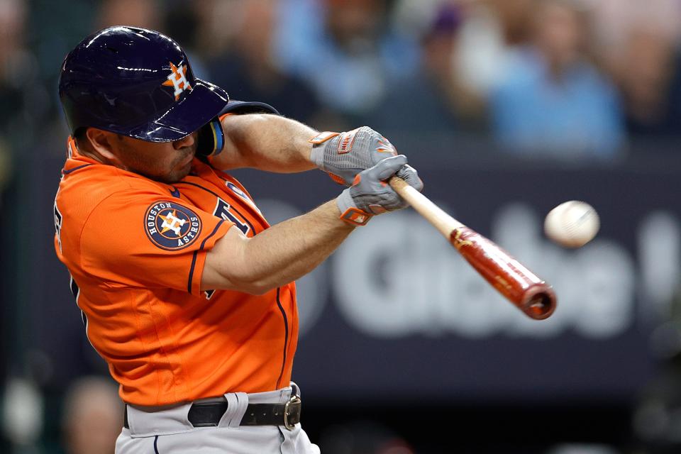 Jose Altuve of the Astros hits a solo home run against Max Scherzer in the third inning.