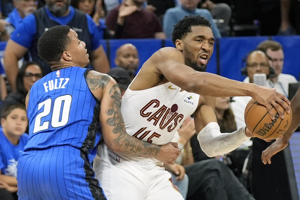 Cleveland Cavaliers guard Donovan Mitchell is fouled by Orlando Magic guard Markelle Fultz (20) as he tries to drives past him during the first half of Game 4 of an NBA basketball first-round playoff series, Saturday, April 27, 2024, in Orlando, Fla. (AP Photo/John Raoux)