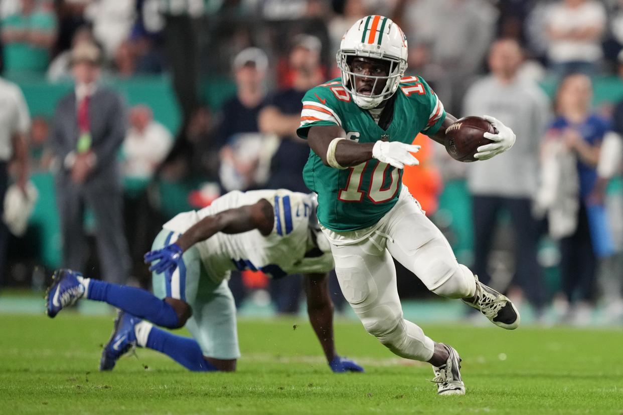 Miami Dolphins wide receiver Tyreek Hill (10) picks up a first down on the Dolphins final drive that lead to a game-winning field goal against the Dallas Cowboys during an NFL game at Hard Rock Stadium in Miami Gardens, Dec. 24, 2023.