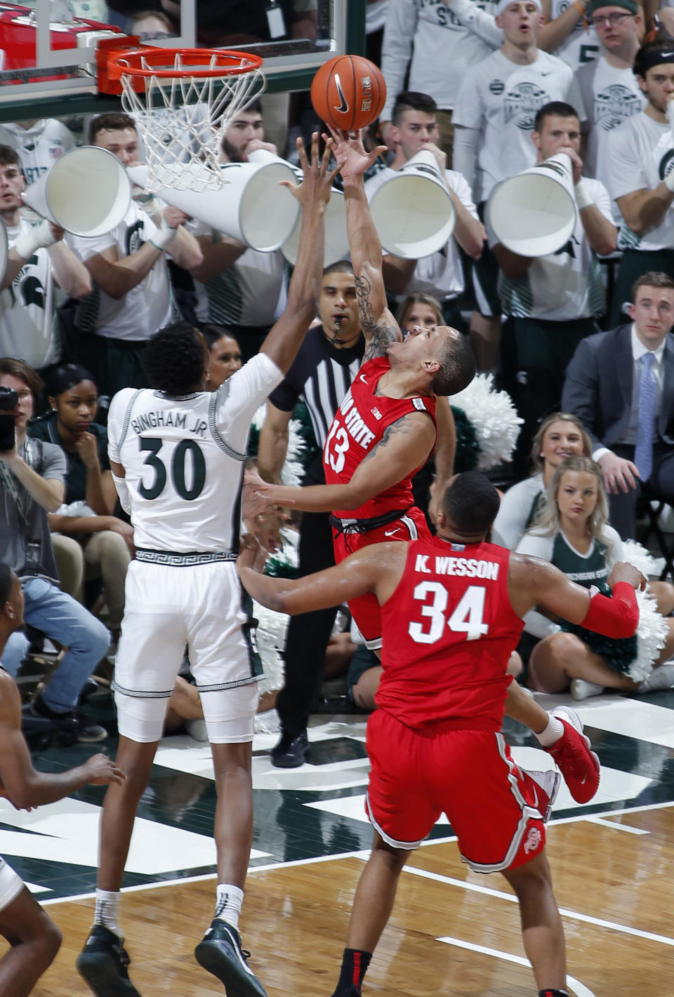 Ohio State's CJ Walker (13) puts up a layup against Michigan State's Marcus Bingham Jr. (30) during the first half of an NCAA college basketball game, Sunday, March 8, 2020, in East Lansing, Mich. (AP Photo/Al Goldis)