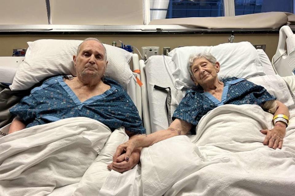 <p>Courtesy of the Stevens family</p> Tommy and Virginia Stevens, both 91, holding hands in one of their final moments together at Vanderbilt University Medical Center in Tennessee.