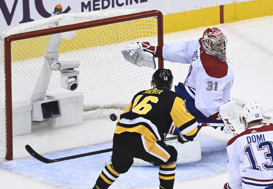 Pittsburgh Penguins left wing Jason Zucker (16) scores past Montreal Canadiens goaltender Carey Price (31) during the third period of an NHL hockey playoff game Monday, Aug. 3, 2020, in Toronto. (Nathan Denette/The Canadian Press via AP)