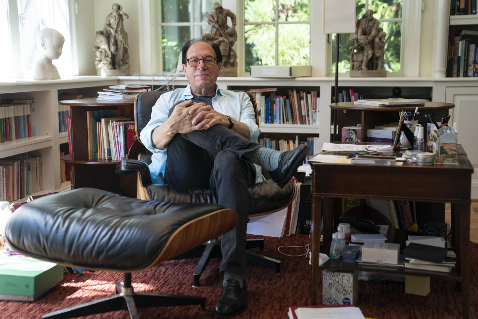 Playwright Ken Ludwig poses for a portrait in his home, Friday, Aug. 12, 2022, in Washington. Ludwig has revisited one of his most beloved plays and flipped the characters’ genders. “Lend Me a Soprano” inverts Ludwig’s madcap screwball comedy “Lend Me a Tenor” by having ladies take the lead three parts, a change he initiated so that a whole new raft of comedians could shine. “Lend Me a Soprano” makes its world premiere this fall at the Ally Theatre in Houston on Sept. 16. (AP Photo/Evan Vucci)