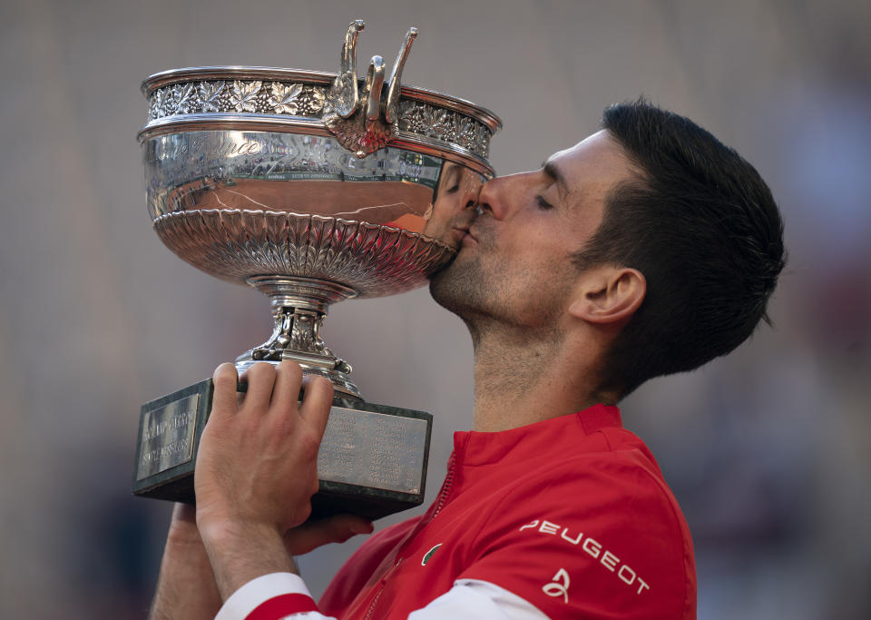 Jun 13, 2021; Paris, France; Novak Djokovic (SRB) kisses the trophy after winning the men's final against Stefanos Tsitsipas (GRE) on day 15 of the French Open at Stade Roland Garros. Mandatory Credit: Susan Mullane-USA TODAY Sports