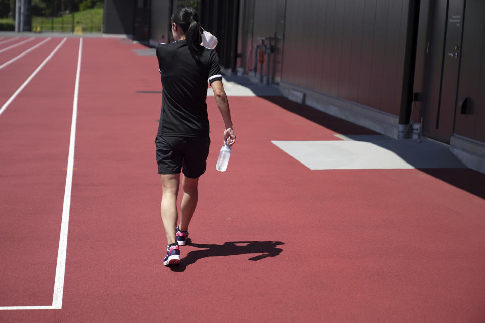 Yoshimi Yamashita of Japan, one of three women picked to be head referees at the men's soccer World Cup, walks after a training session, Monday, June 27, 2022, at JFA YUME Field in Chiba, near Tokyo. (AP Photo/Eugene Hoshiko)