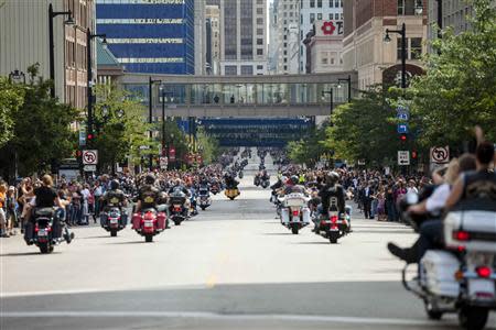 Spectators line the street as Harley riders participate during the the Harley Davidson 110th Anniversary Celebration parade in Wisconsin Avenue, Milwaukee August 31, 2013. REUTERS/Sara Stathas