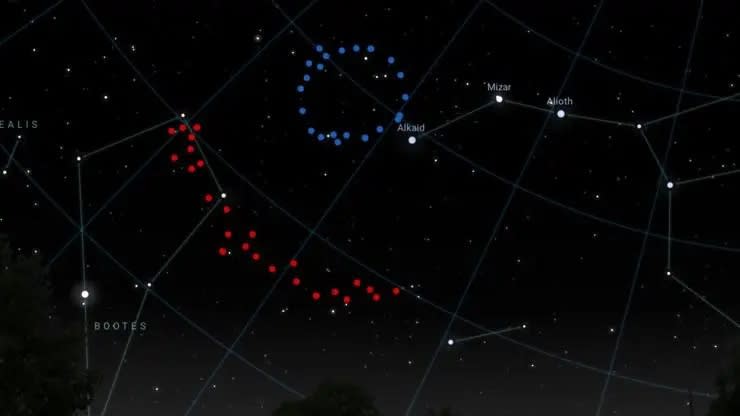  A view of the sky with one dotted blue circle toward the top center and a dotted red art to the middle left. 