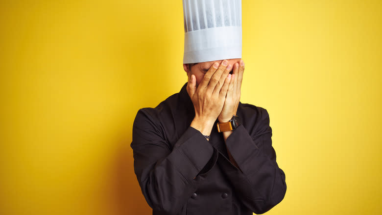 embarrassed chef covering his face