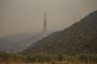 The Kemerkoy Power Plant, a coal-fueled power plant, in Milas, Mugla in southwest Turkey, Thursday, Aug. 5, 2021. A wildfire that reached the compound of a coal-fueled power plant in southwest Turkey and forced evacuations by boats and cars, was contained on Thursday after raging for some 11 hours, officials and media reports said. (AP Photo/Emre Tazegul)