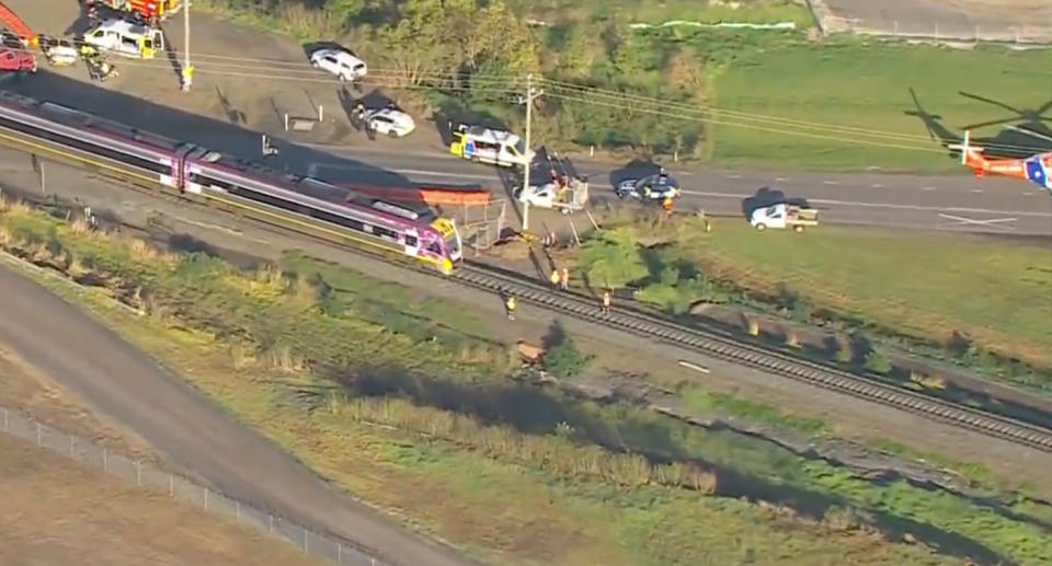 An aerial shot of the train surrounded by first responders and several emergency vehicles. 